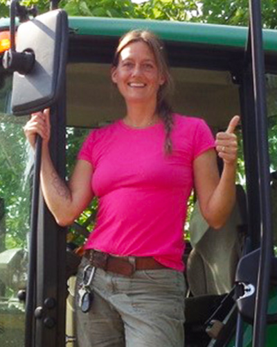 Laurel Franklin standing in the cab of a Parks Department vehicle.