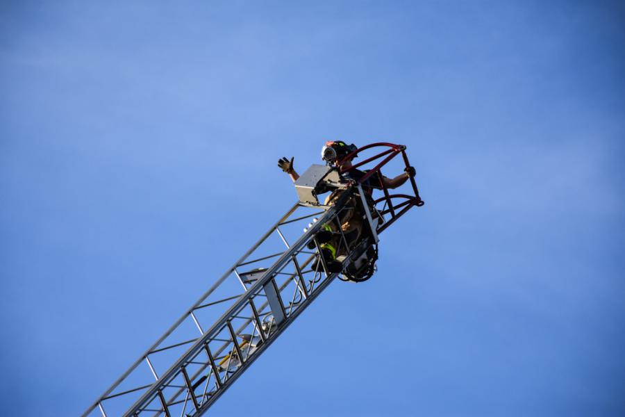 Firefighter Dykstra at top of aerial ladder