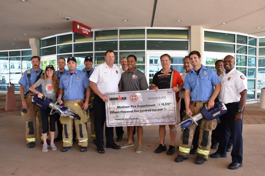 MFD personnel with giant check