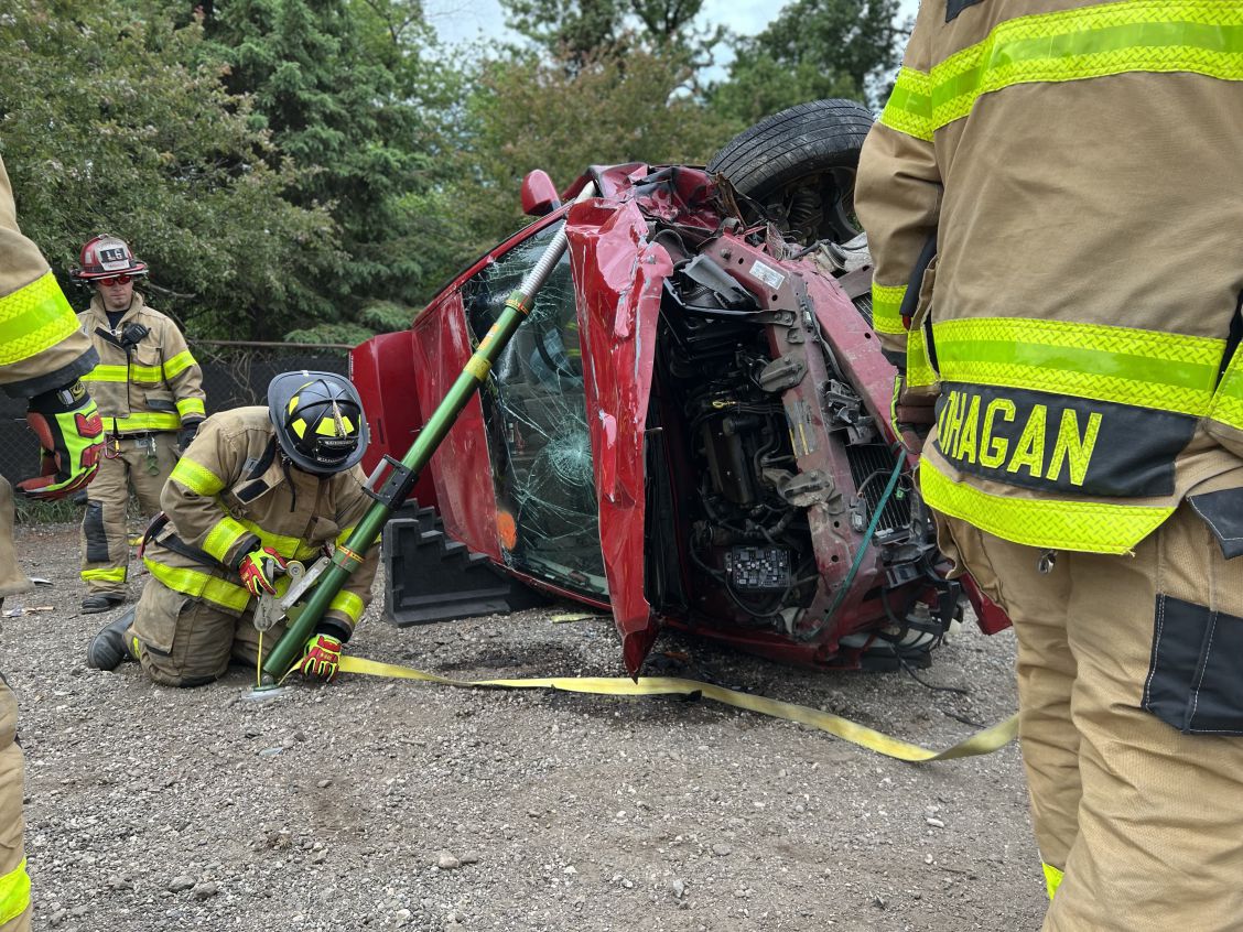 Firefighter stabilizes a turned over vehicle during extrication training