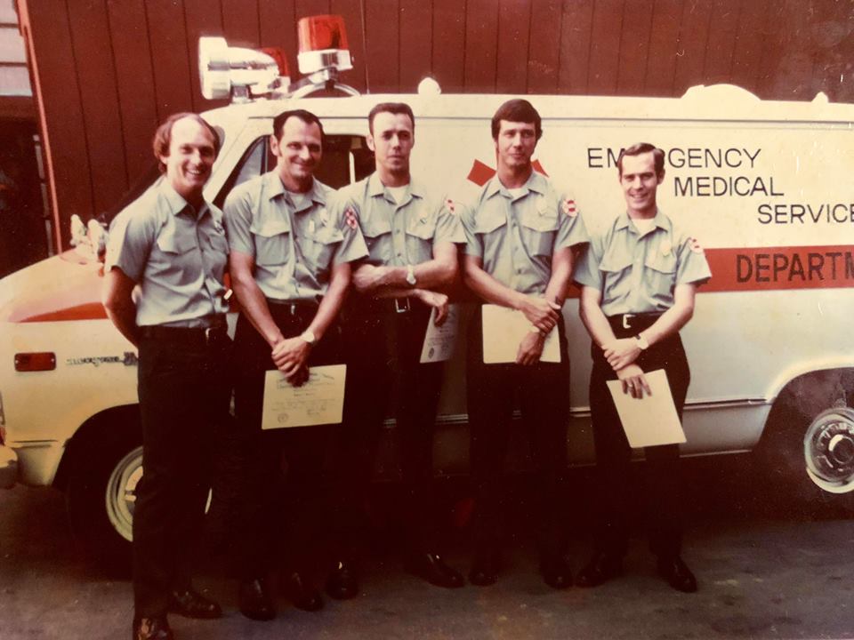 the first five MFD paramedics stand next to Rescue 62