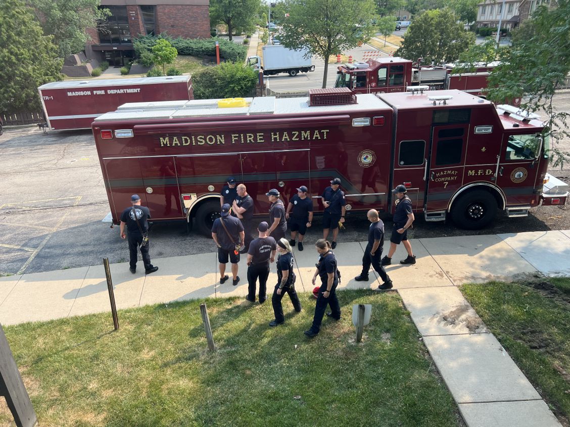 A view of HIT 7 and other MFD rigs on the street with team members standing nearby