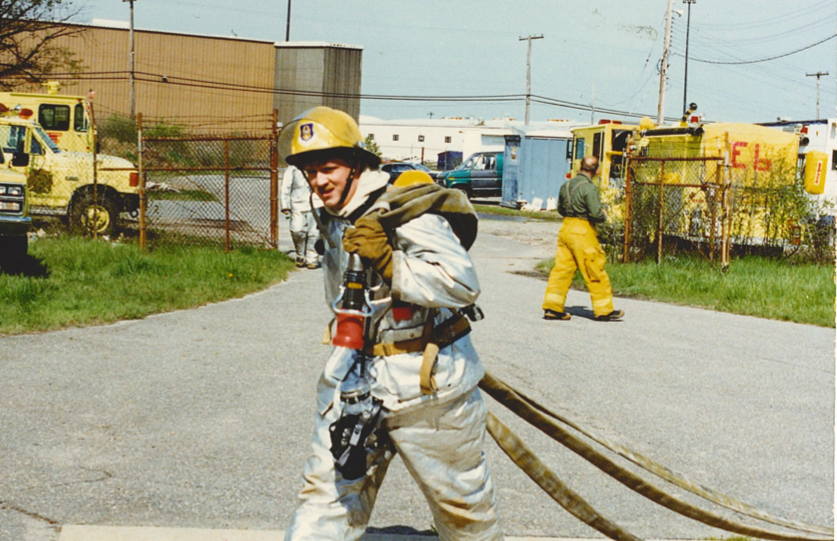 Popovich carrying hose during military training