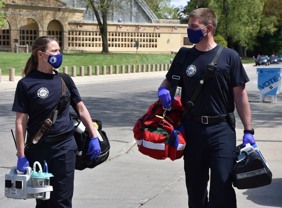 paramedics walking with equipment in hand