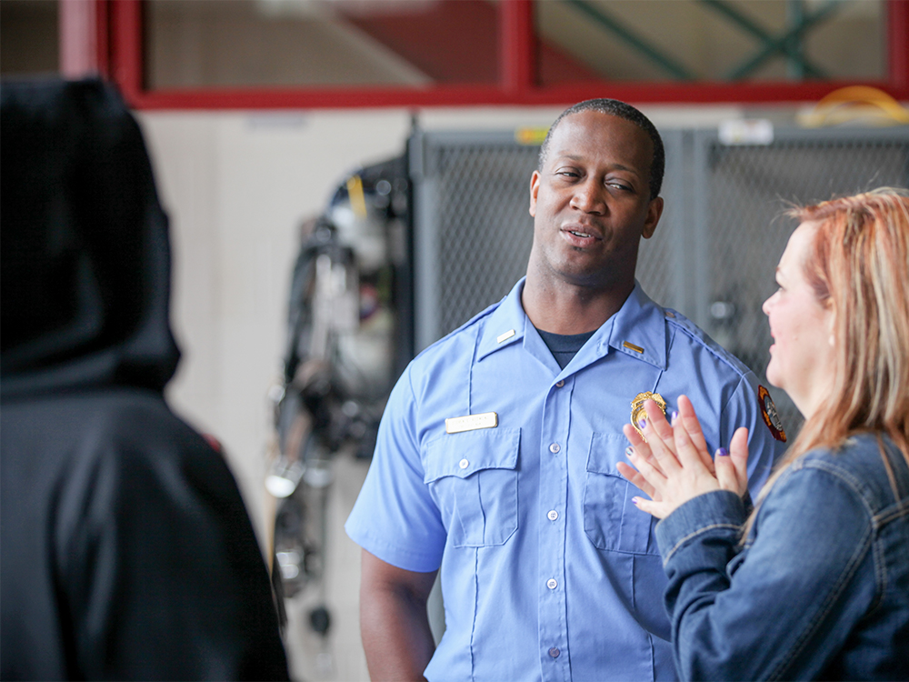 Firefighter talks to a visitor at the fire station