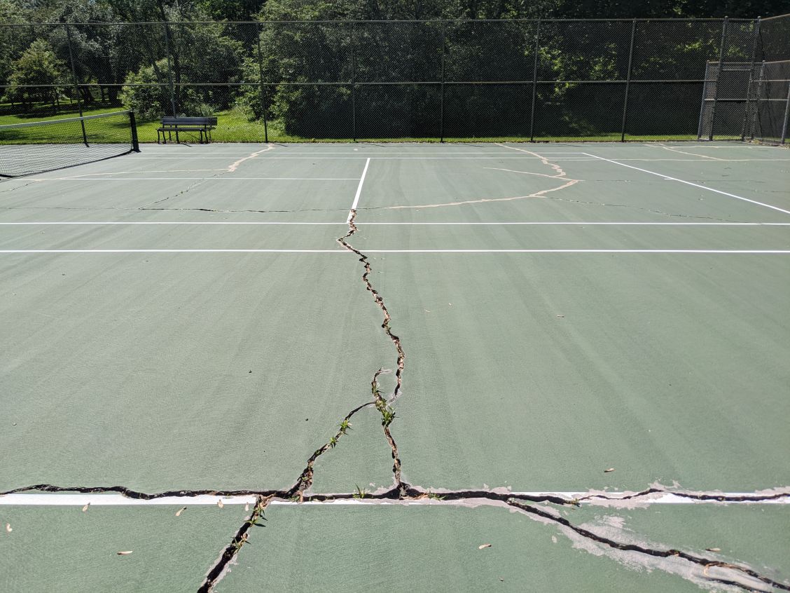 Photograph of the cracks at Westmorland Park courts prior to maintenance repair work