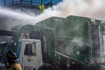 Water spraying onto recycling truck