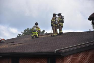 Firefighters on rooftop of St. Paul Lutheran Church