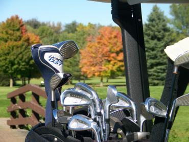 golf clubs closeup with fall background