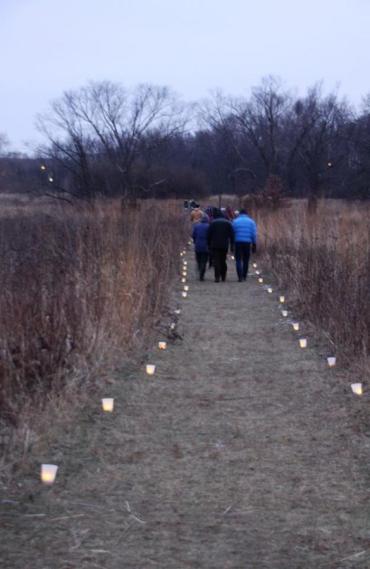 candlelit walk with people on trail