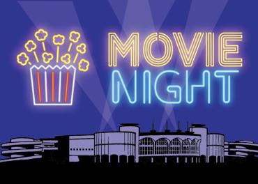 bucket of popcorn and the words "Movie Night" projected over Monona Terrace