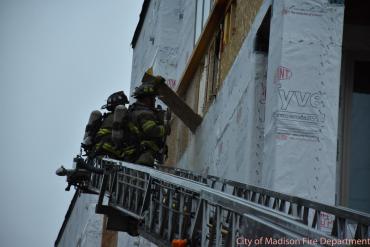 firefighters pulling away the wall