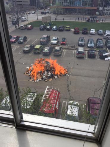 Trash fire in parking lot