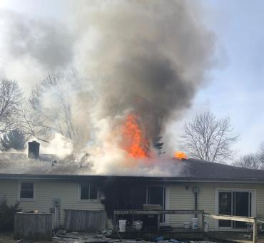 Flames and smoke venting through roof