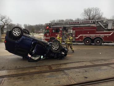 Upside-down vehicle with Ladder 6 and firefighters