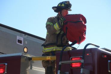 Firefighter retrieves rescue equipment
