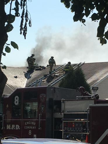 Firefighters and smoke on rooftop