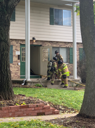 Firefighter entering apartment building on E. Karstens Drive