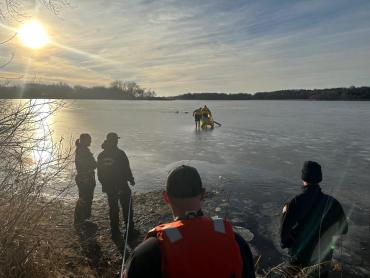 Wide view of Lake Rescue team members taking the rapid deployment craft out to the patients