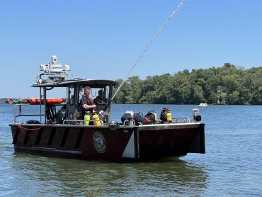 A close-up photo of the Lake Rescue boat spraying water