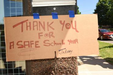 Sign made of brown cardboard taped to tree saying "Thank you for a SAFE school year"