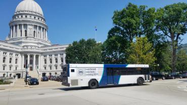 Metro bus driving past Capitol Building