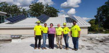 Mayor Satya Rhodes-Conway, City Engineering Division Staff, GreenPower Staff on the roof of Goodman Maintenance Facility 