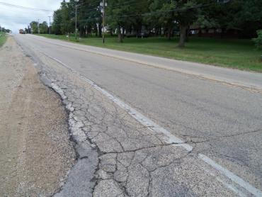 Photo shows deteriorating pavement on Cottage Grove Road. 