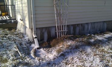 Water leaking and freezing beneath home's siding