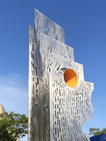Detail of the top portion of "Both/And – Tolerance/Innovation" showing the yellow portal that intersects the vertical steel 