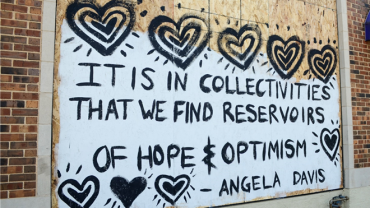 Street art from State Street says, "It is in collectivities that we find reservoirs of hope and optimism"-Angela Davis