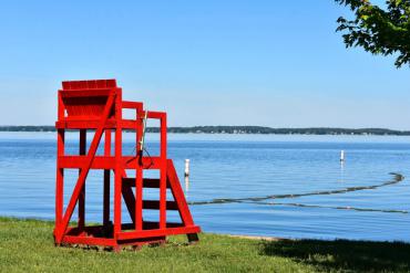 Red lifeguard chair overlooking beach