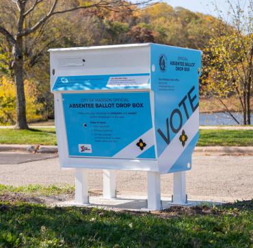 Blue and white absentee ballot drop box in the City of Madison. Drop box is located near the pond at Elver Park on the city's west side.
