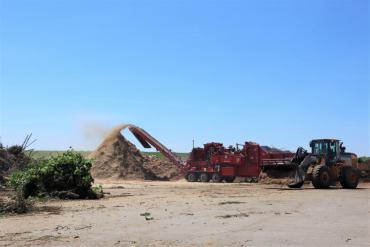 Industrial grinder making mulch at 121 E. Olin Ave. 