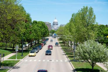 Cars driving on Madison street with Capitol building