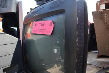 Here is an old CRT TV with its $15 recycling fee sticker slapped right on the screen.