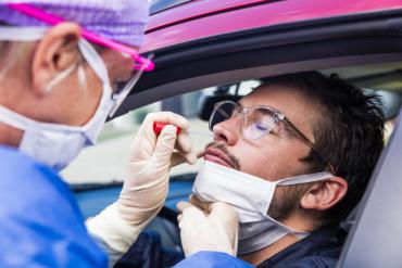 A person in their car being tested for COVID-19 