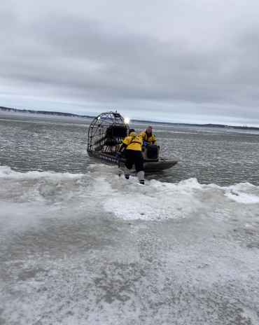 Lake Rescue Team placing swan into ice boat