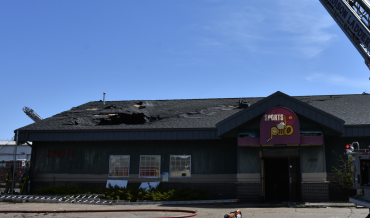 Front of business with hole in roof