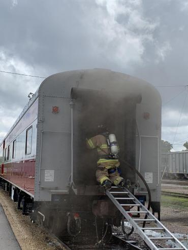 Firefighter entering smoky railroad car