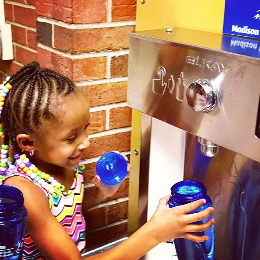 Girl stops by refilling station at Lindbergh Elementary