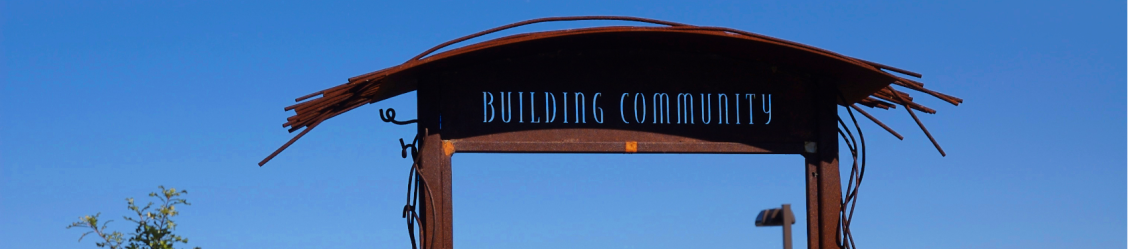 rustic looking sign that says "Building Community"