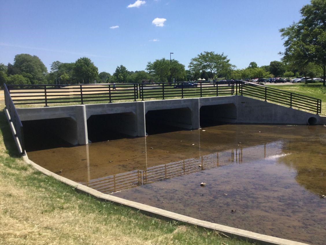 The image shows the newly constructed box culverts under McKenna Boulevard.  There are two 5-foot by 10-foot culverts and two 5-foot by 12-foot culverts.