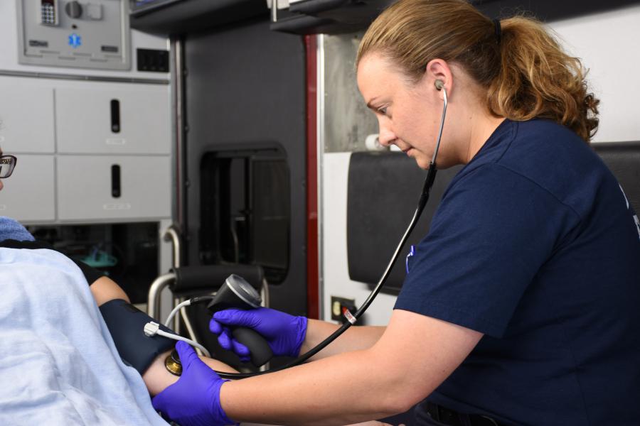 Paramedic Raena Glauvitz Taking Blood Pressure