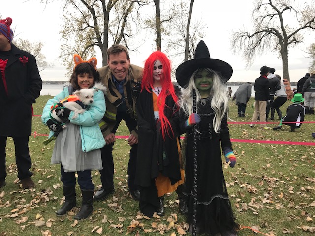 Firefighter Patrick Kearney with kids in witch costumes
