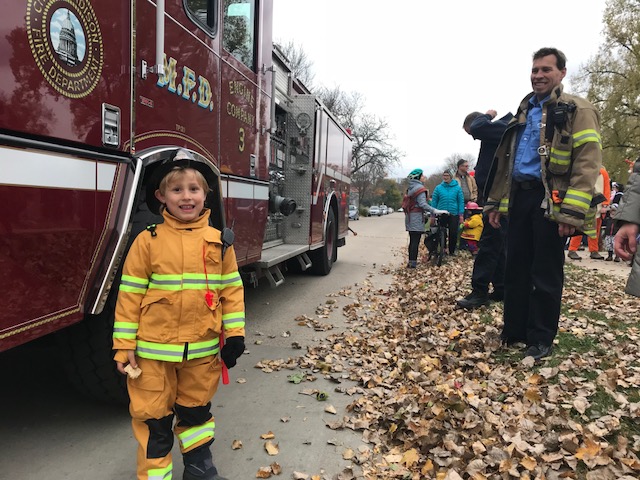 Kid in firefighter costume with Engine 3