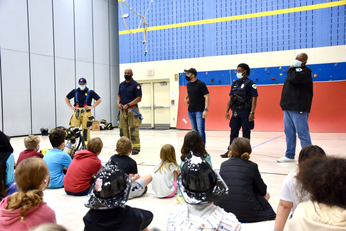 firefighters and police officers answer students' questions