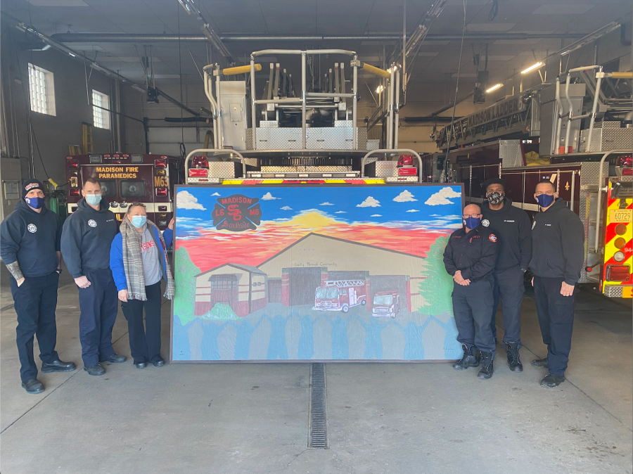 Betty Groom and Station 6 firefighters standing by painting