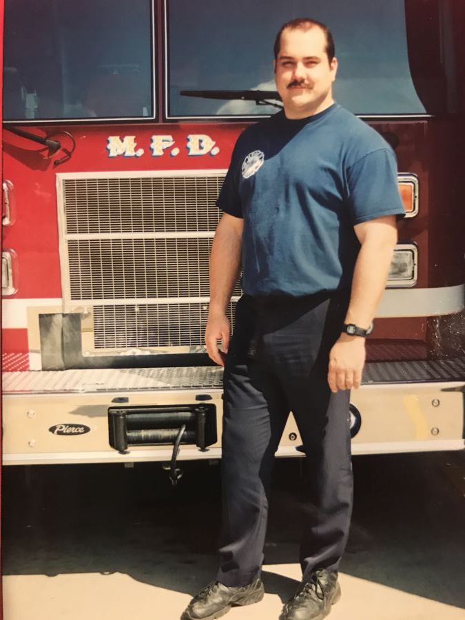 Jon Byrd standing by fire engine