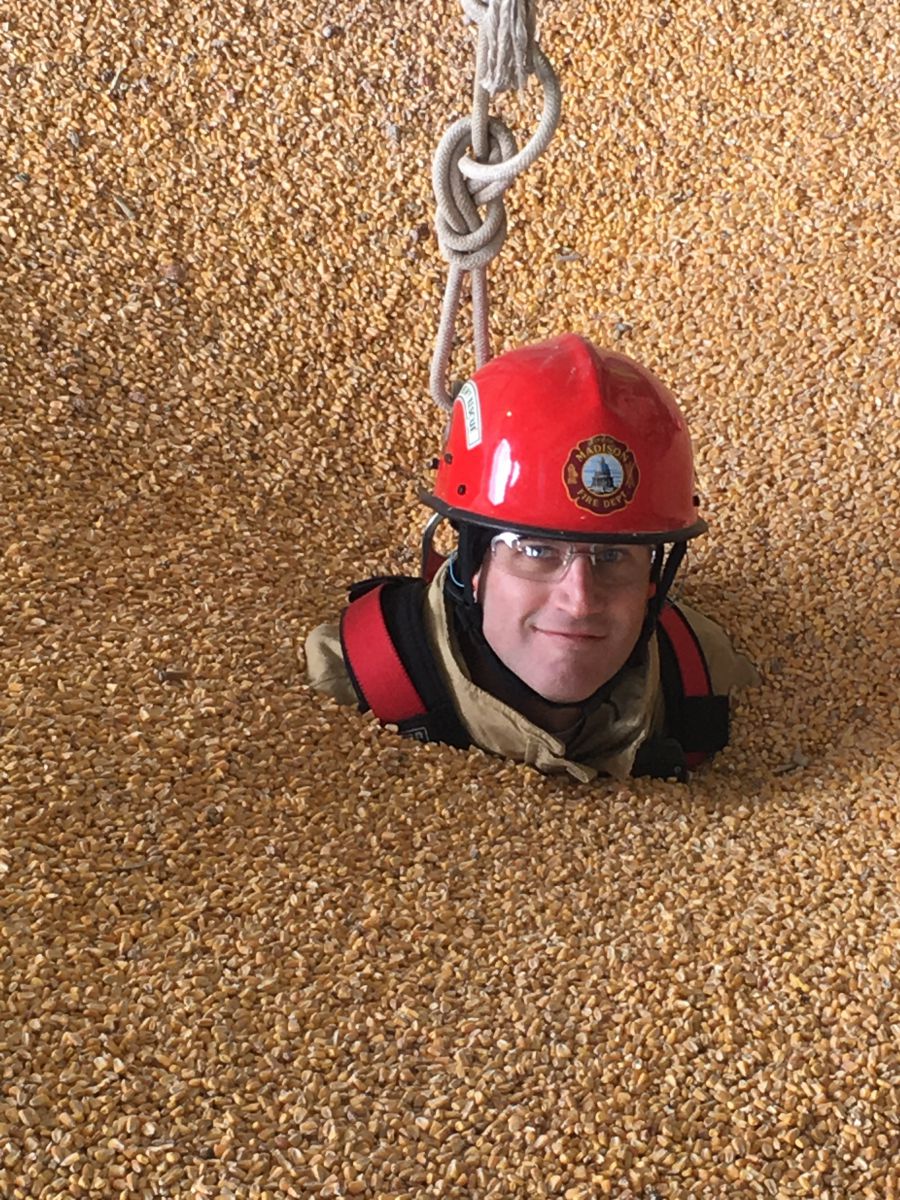 Firefighter McGinnis in corn-filled grain bin